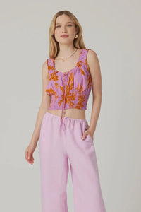 Woman in a pink floral crop top and wide-leg pants for a boho free spirit look