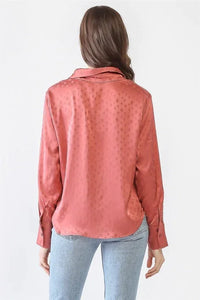 Woman in pink shirt and jeans wearing a Satin Diamond Print Button-Up Long Sleeve Top