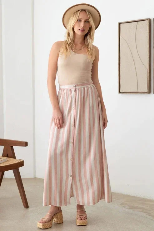 Woman in a pink and white striped maxi skirt with elastic waist, the Boho Front Button design