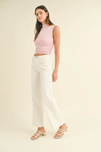 Woman in pink top and white pants wearing Slim Wide Leg Jeans for a stylish look