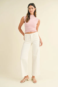 Woman in a pink top and white pants showcasing Midrise Slim Wide Leg Denim Jeans