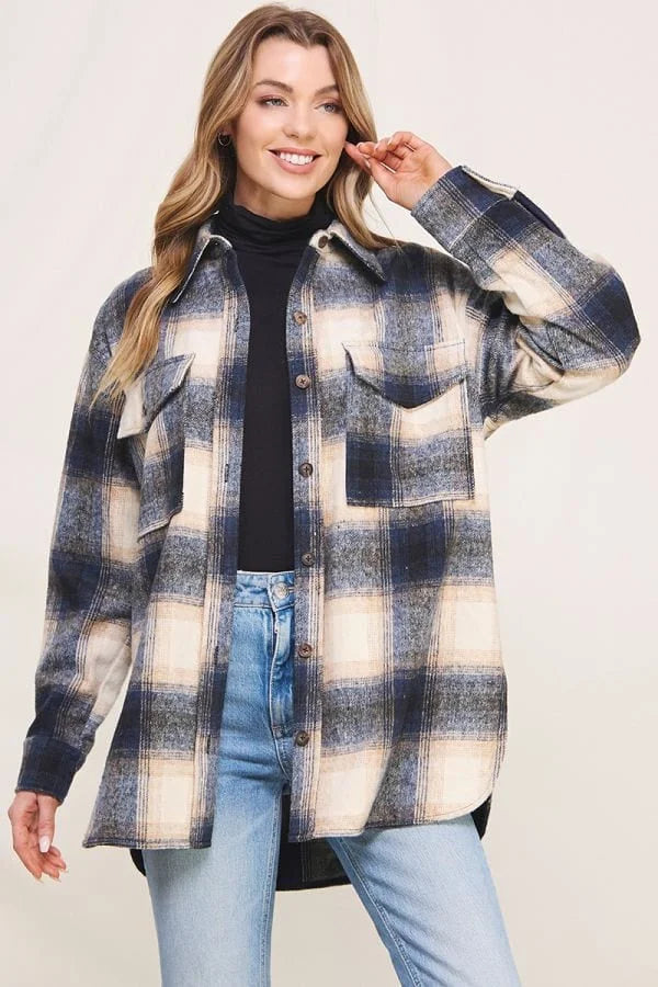 Smiling woman in plaid jacket from Shop Daisy, a staple of women’s boho chic clothing