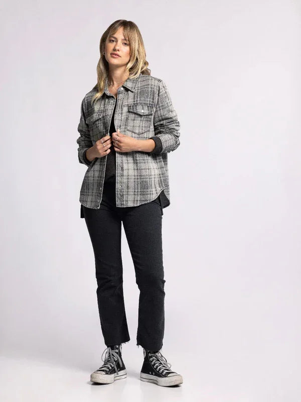 Woman in a plaid denim Pippin jacket, dark pants, and sneakers for a stylish look