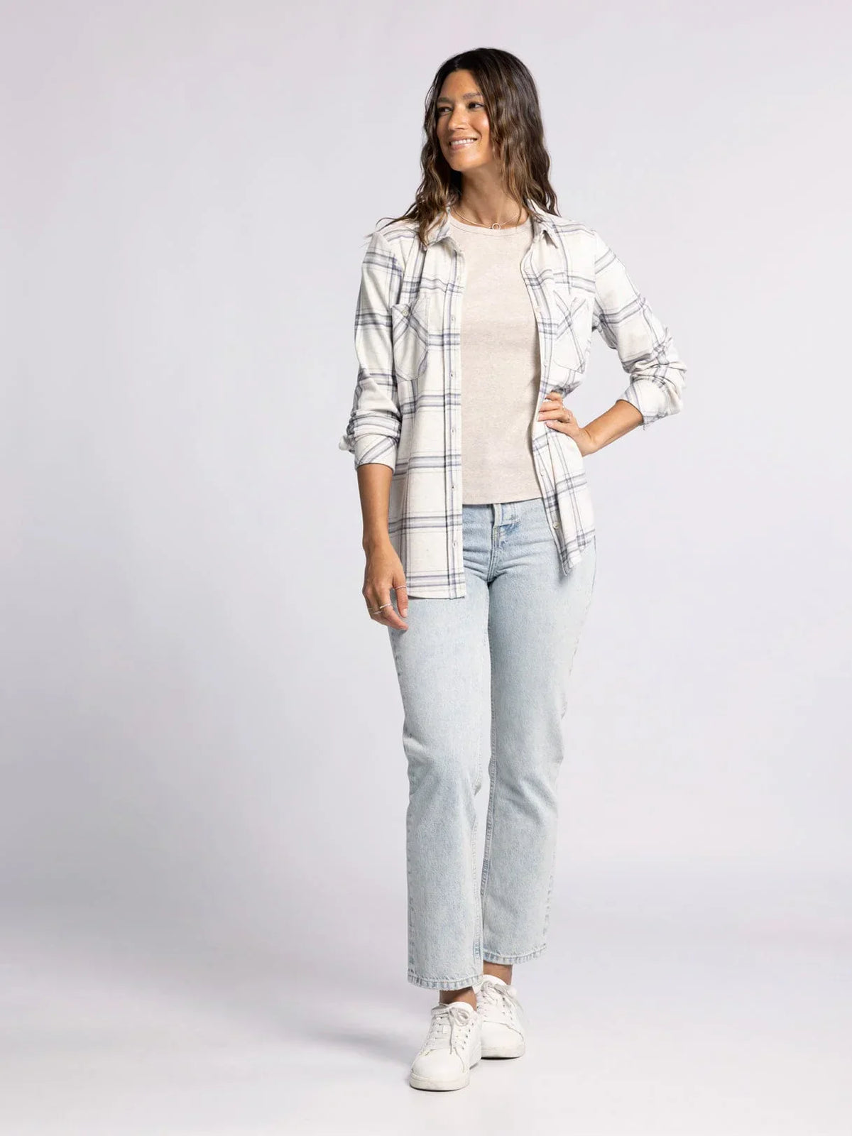 Woman in plaid shirt over white top, showcasing the Plush Collared Button Down Top