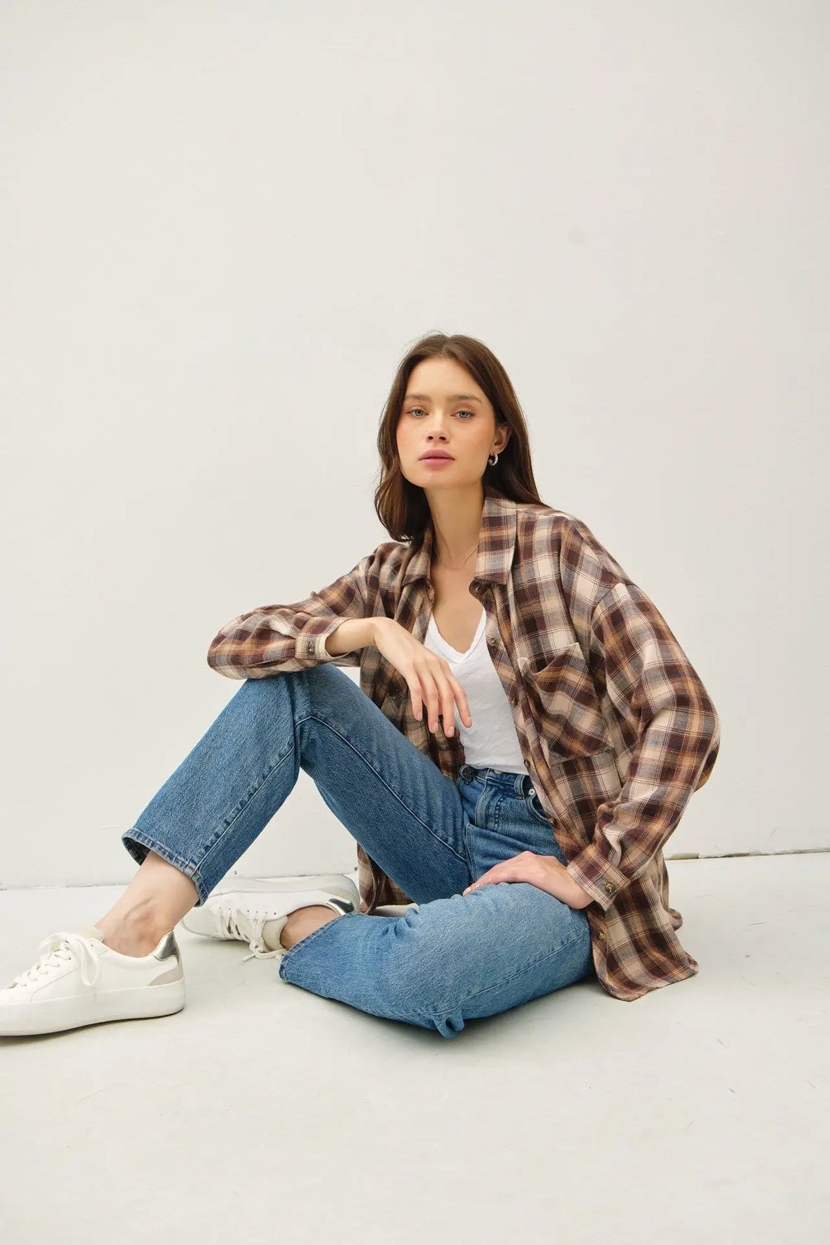 Woman wearing ultra soft oversized flannel shirt and jeans in a stylish setting