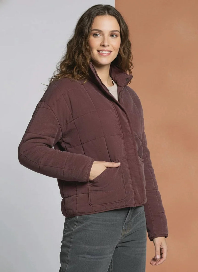 Woman wearing the THREAD AND SUPPLY BRINA JACKET in burgundy and dark gray pants
