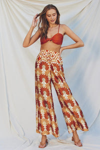 Woman in red crop top showcasing Bohemian wide leg GOLDEN AGE pants