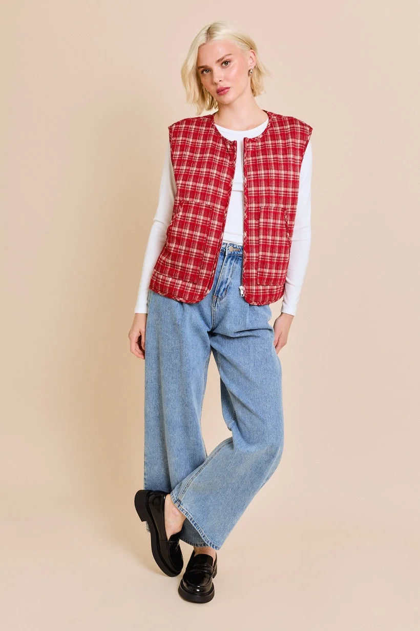 Woman in red plaid vest jacket over white shirt, showcasing women’s boho chic clothing