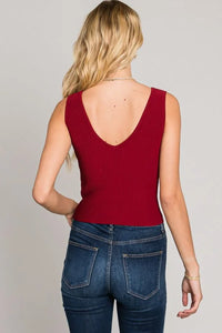 Woman in red sleeveless top and blue jeans showcasing Bodycon Techno Rib V-Neck Tank