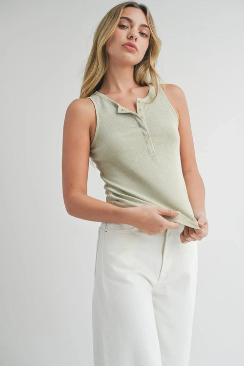 Woman in a rib tank top and white pants, showcasing women’s boho chic clothing from Shop Daisy