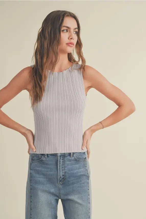 Woman in ribbed knitted tank top and jeans, featured in Shop Daisy’s women’s boho chic clothing