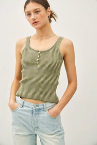 Woman wearing striped knit button-up Henley tank top with distressed jeans