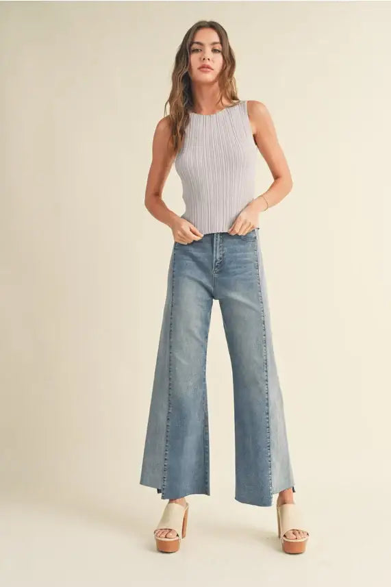 Woman in a ribbed knitted tank top and wide-leg jeans from Shop Daisy’s boho chic clothing