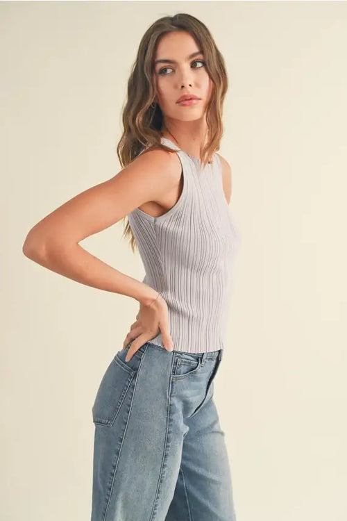 Woman in ribbed knitted top and jeans showcasing women’s boho chic clothing from Shop Daisy