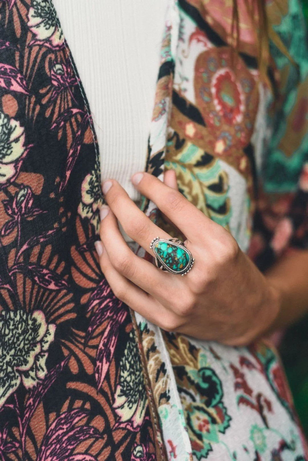 Woman showcasing the Turquoise Raindrop Adjustable Ring with a vibrant turquoise stone