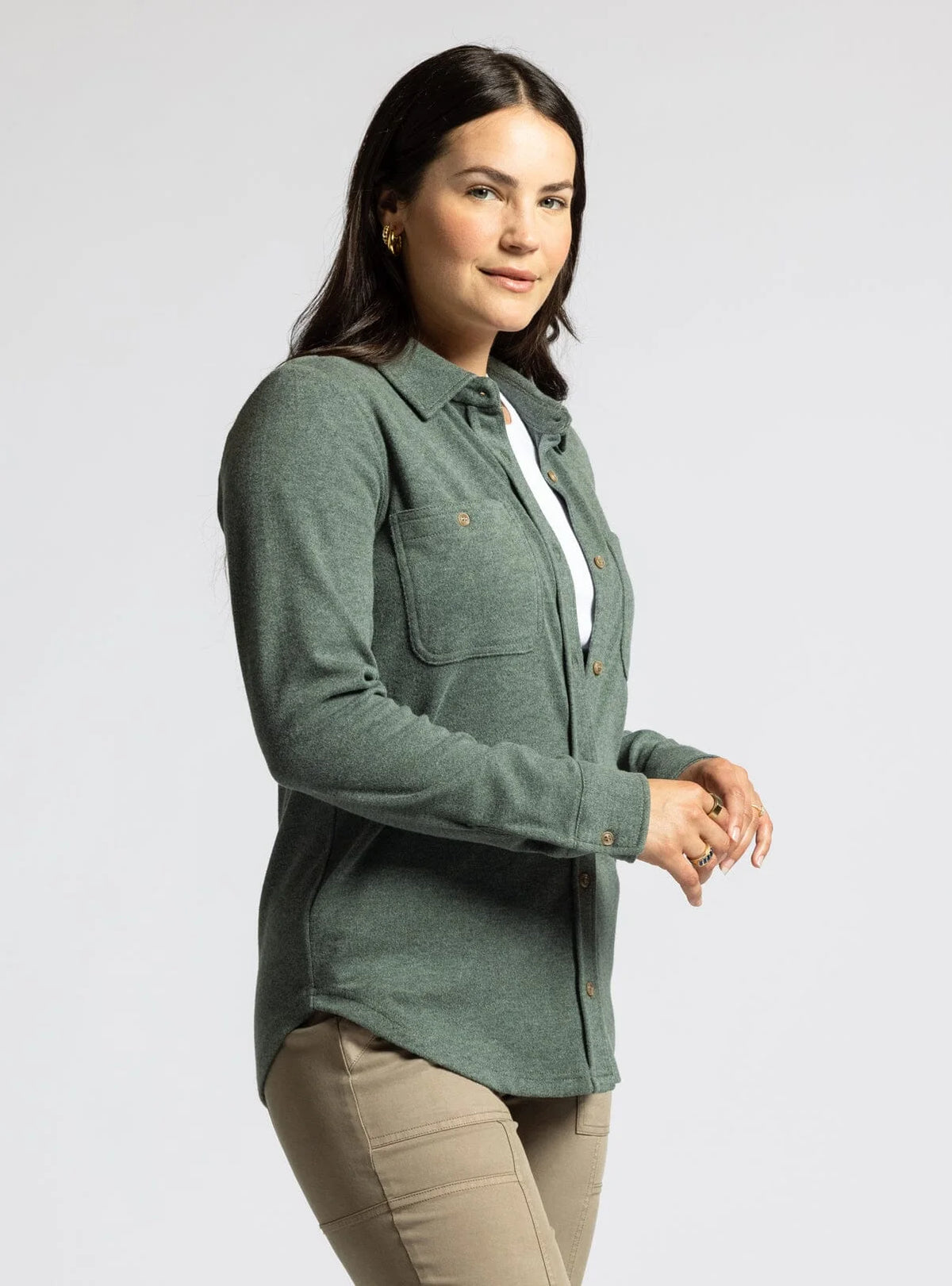 Woman in a sage green plush collared button down top with khaki pants