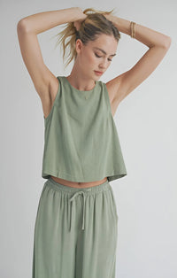 Woman in sage green Sugarloaf Linen Tank with matching drawstring pants