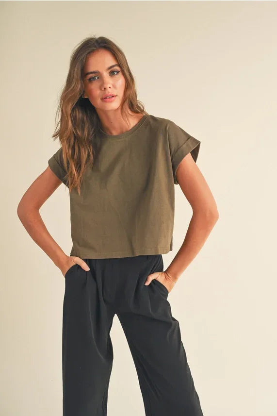 Woman modeling olive green round neck cuffed sleeve crop top with black wide-leg pants