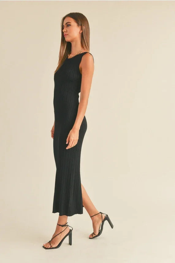 Woman modeling patterned rib knitted long dress with sleeveless fit and high heels