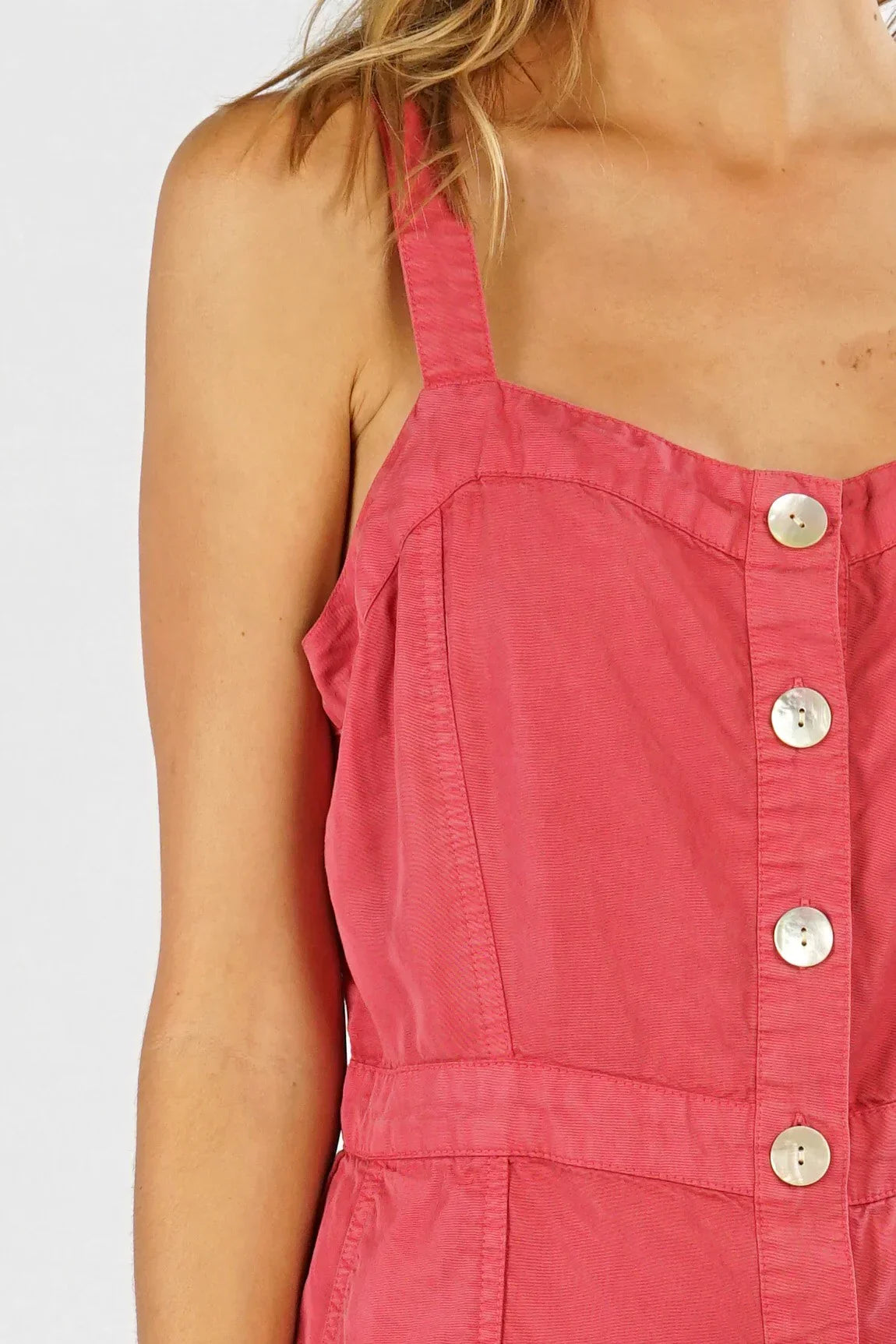 Woman wearing a sleeveless midi dress in red TENCEL BUTTON UP fabric