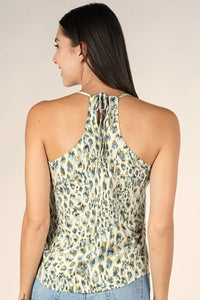 Woman modeling animal print spaghetti strap tank with subtle leopard pattern in green and blue