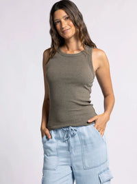 Woman in olive green Edlin Basic Tank and light blue cargo shorts