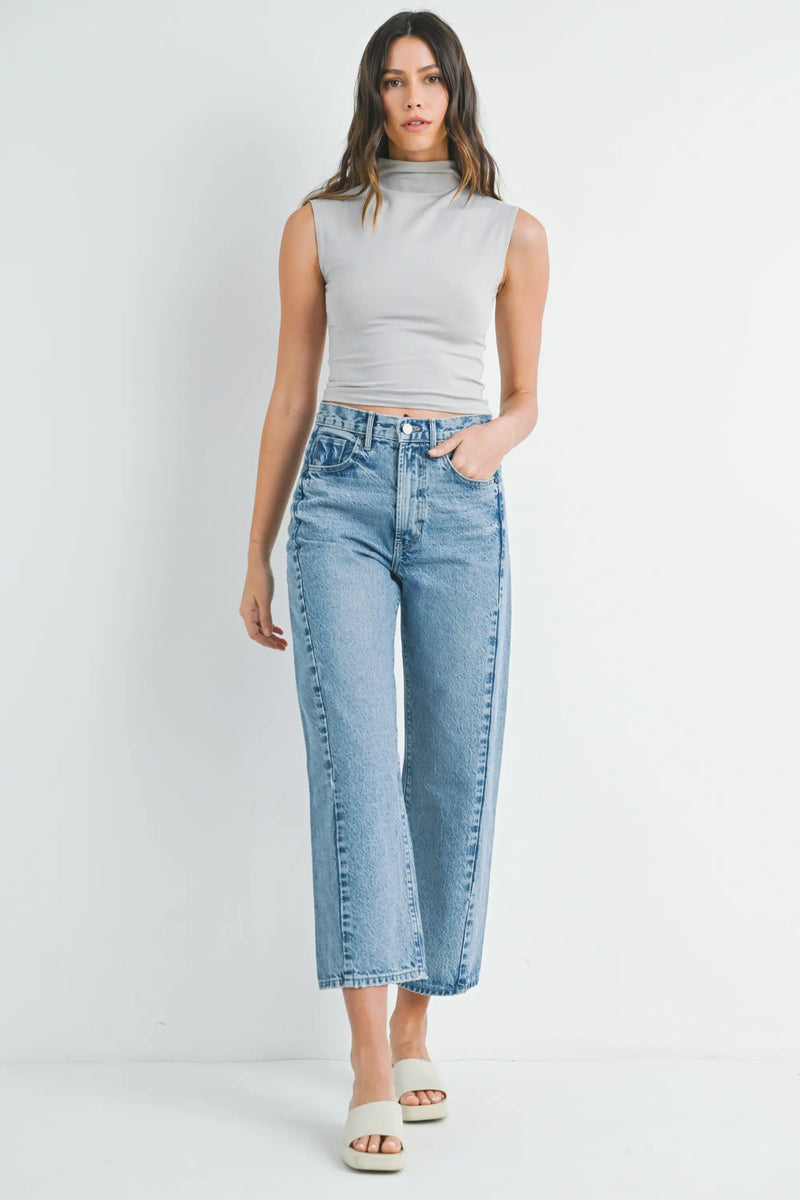 Woman in a sleeveless top and wide-leg jeans from HIGH RISE BARREL DENIM JEAN TWIST