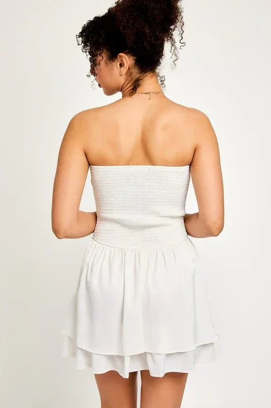 Woman in a smocked bodice tube dress, showcasing the elegant back design