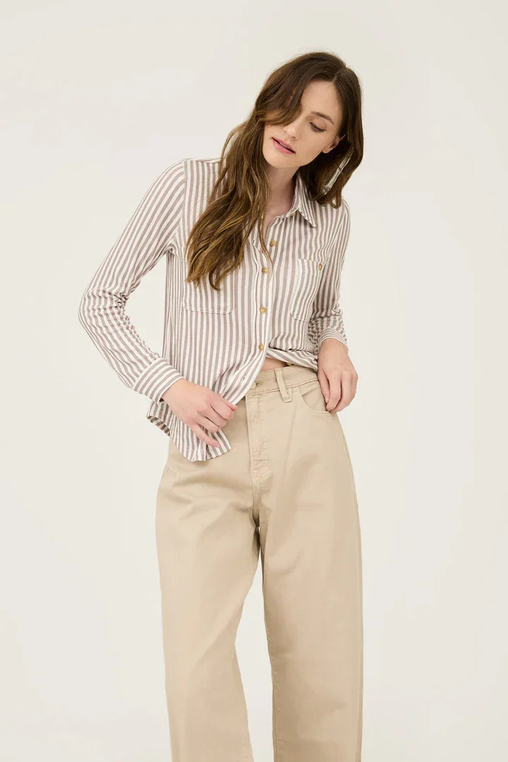 Woman modeling a Stripe Collared Long Sleeve Button Down Shirt with beige trousers