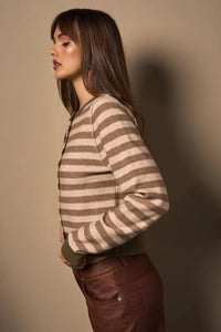 Woman wearing a long sleeve stripe Kint cardigan with brown leather pants
