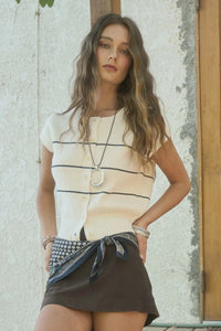 Woman wearing striped cardigan and mini skirt from Shop Daisy women’s boho clothes