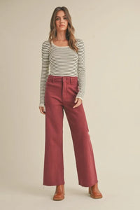 Woman in striped long-sleeve top and wide-leg burgundy pants from Shop Daisy’s women’s boho chic clothing