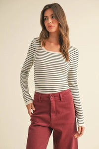 Woman in striped long-sleeve knitted top and burgundy pants from Shop Daisy’s women’s boho chic clothing