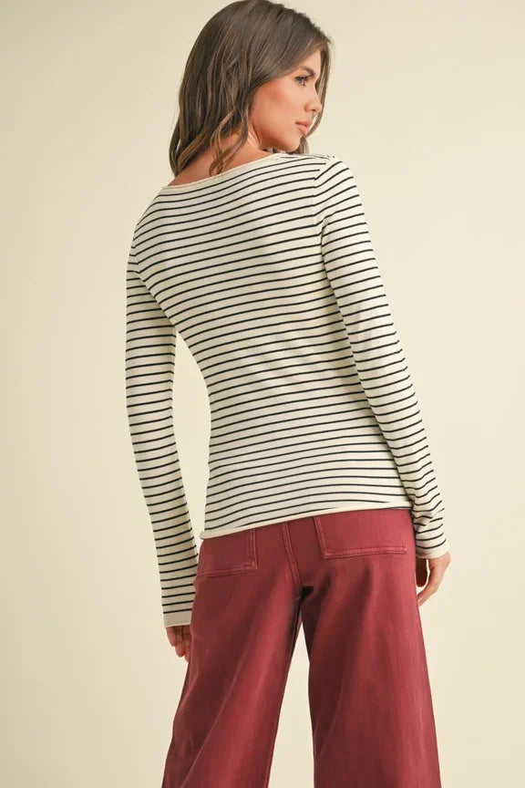 Woman in striped long-sleeved top and burgundy pants from Shop Daisy’s women’s boho chic clothing