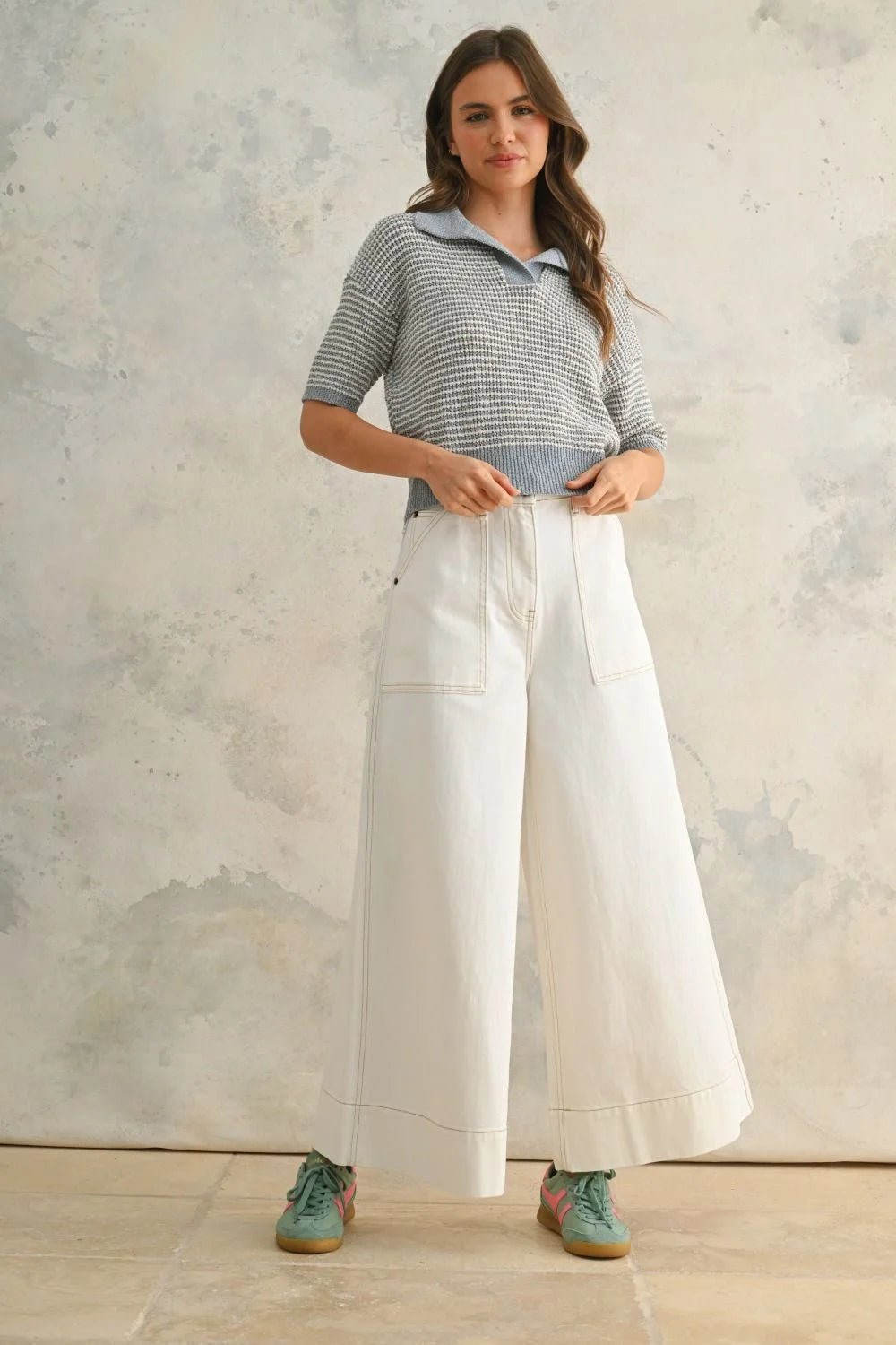 Woman wearing striped polo shirt and wide-leg pants in women’s boho chic clothing style