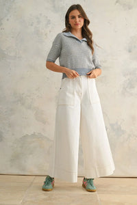 Woman wearing striped polo shirt and wide-leg pants in women’s boho chic clothing style