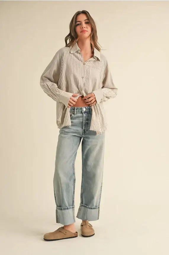 Woman in multi stripe pattern buttondown shirt and jeans showcasing casual style