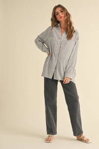 Woman in striped shirt and jeans wearing size small, perfect for women’s boho chic clothing from Shop Daisy
