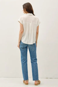 Woman wearing a stylish short sleeve striped shirt and jeans showcasing the striped shirt style