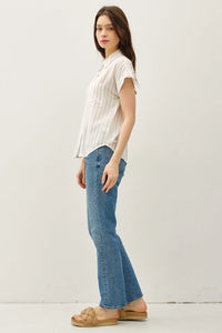 Woman modeling a short sleeve striped shirt in casual fashion style