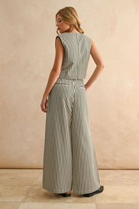 Woman wearing striped pattern wide leg pants and sleeveless top in stylish fashion