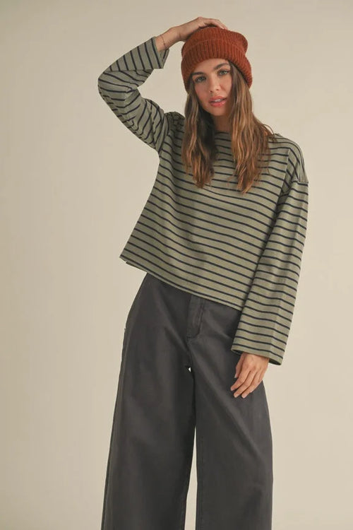 Woman in a striped pattern long sleeve top, showcasing women’s boho chic clothing from Shop Daisy