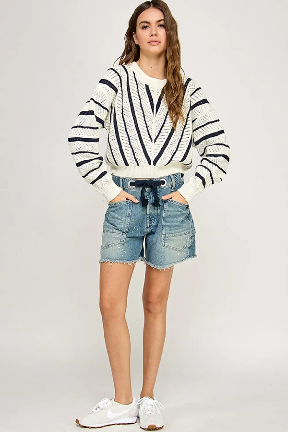 Woman wearing V-Striped Knit Sweater, a stylish women’s boho chic clothing piece from Shop Daisy