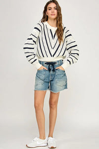 Woman wearing V-Striped Knit Sweater, a stylish women’s boho chic clothing piece from Shop Daisy