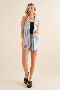 Woman in striped sleeveless cardigan vest styled for a boho, flowy look