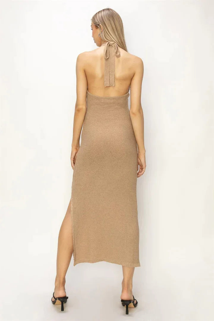 Back view of a woman in a tan Halter Neck Midi Dress showcasing elegant style