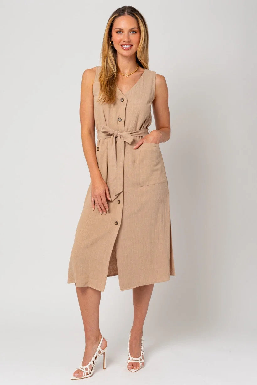 Woman modeling a sleeveless button down midi length dress with a band tie front