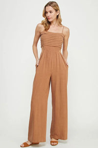 Woman modeling a soft linen jumpsuit, showcasing an elegant style for women