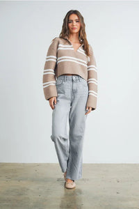 Woman wearing stripe crop collar sweater top with light wash wide-leg jeans and tan flats