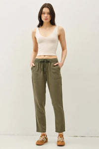 Woman wearing TENCEL Tapered Pants and tank top showcasing stylish tapered pants